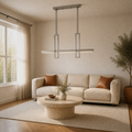 Living room | brushed nickel linear pendant over a travertine coffee table