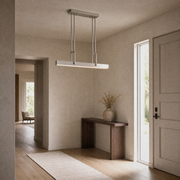 Entryway | brushed nickel pendant in a greige entry with a walnut console