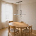 Dining room angle | brushed nickel pendant over a round oak table from three-quarter view