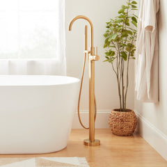 Lexia Floor Mounted Tub Filler Faucet with Hand Shower and Valve in Brushed Gold | product photo