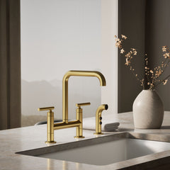 Kohler Purist Two Handle Deck-Mounted Bridge Kitchen Sink Faucet with Side Spray in Vibrant Brushed Moderne Brass | product photo