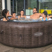 Family | Five people gathered around the spa in an indoor-outdoor evening setting