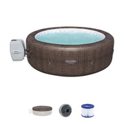 Front | Brown woven round hot tub shown with the pump, cover, chemical floater, and filter cartridges