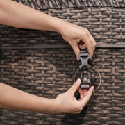 Buckle detail | Hand fastening a strap buckle on the tub's woven exterior wall