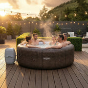 Patio | Five adults relaxing together in the bubbling spa on a lit deck at dusk