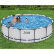 Backyard | Family swimming in the filled gray round pool on a lawn