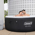 In use | Two adults relaxing together in the filled round hot tub outdoors