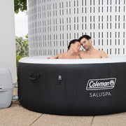 In use | Two adults relaxing together in the filled round hot tub outdoors