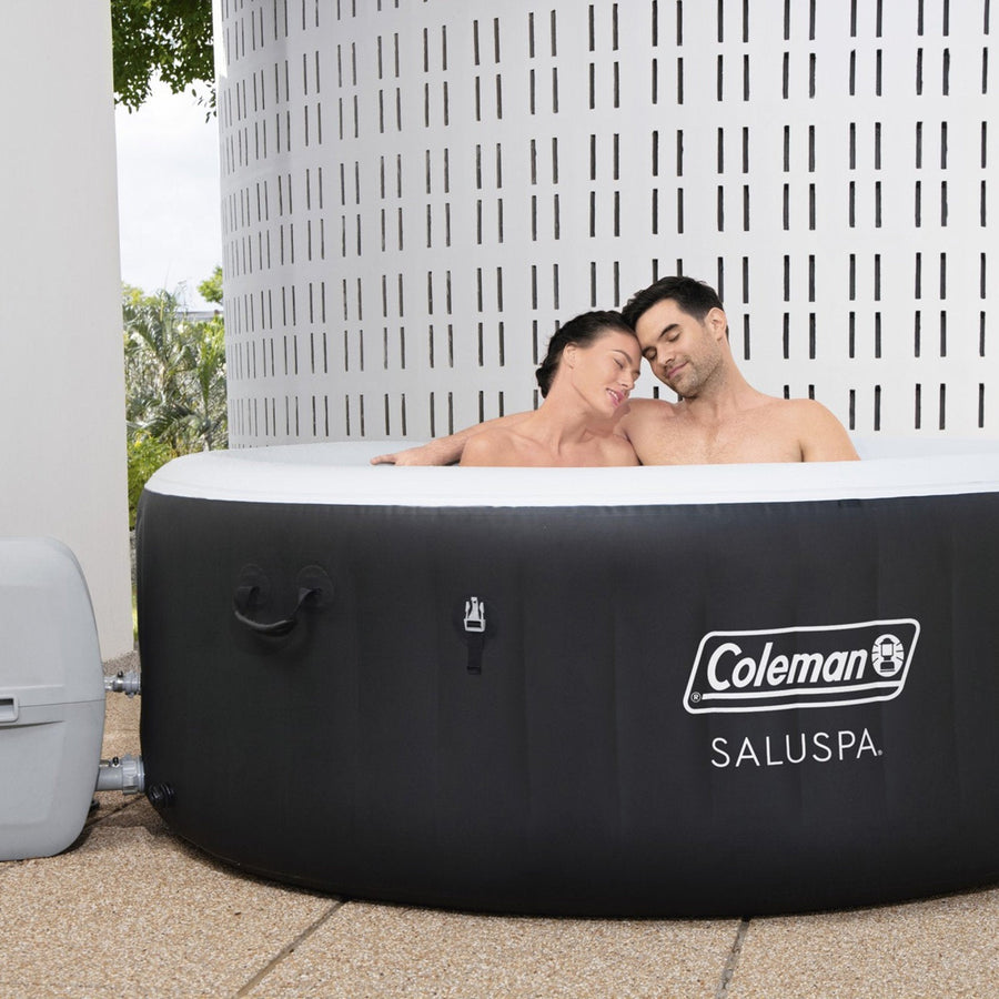In use | Two adults relaxing together in the filled round hot tub outdoors