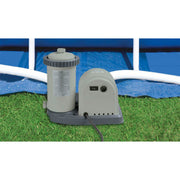 Pump | Gray cartridge filter pump with a timer dial and on off switch on grass