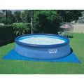 Backyard | Filled 18 foot Easy Set ring pool on a blue ground cloth in a backyard
