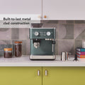 Set contents | KitchenAid KES6551 portafilter, filter baskets, measuring scoop, and cleaning brush accessories