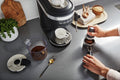 Lifestyle | KitchenAid KES6403BM espresso machine on countertop with accessories and cups