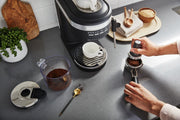 Lifestyle | KitchenAid KES6403BM espresso machine on countertop with accessories and cups
