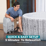 Setup | Man connecting the hose between the pump and the hot tub wall