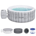 Front | Covered gray woodgrain hot tub with bubbling water and included accessories on a white background