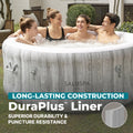 Family | Four people smiling together in the bubbling spa in a garden setting