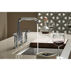Kohler Purist Two Handle Deck-Mounted Bridge Kitchen Sink Faucet with Pull Out Side Sprayer in Polished Chrome | product photo