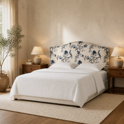 Angle | Three-quarter view showing the camelback silhouette, nailhead trim, and legs