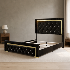 Room 2 | Black and gold upholstered bed against a clay-toned bedroom shell