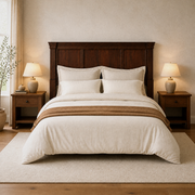 In a room | Centered wood headboard in a warm bedroom with matching nightstands, lamps, bedding and a rug