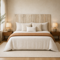 In a room | Wood panel headboard centered against a textured wall above a made bed with matching nightstands