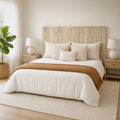 Airy corner | Corner view of the wood panel headboard in a bright room with pale oak furniture and a low rug