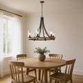 In a room | wood wagon-wheel chandelier hanging over a round oak table