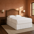 Clay corner | Angled view of the arched rattan headboard in a warm clay bedroom