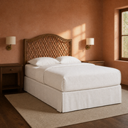 Clay corner | Angled view of the arched rattan headboard in a warm clay bedroom