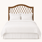 Front | Straight-on studio view of the arched rattan headboard with open diamond lattice