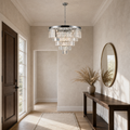 In an entryway | the same chandelier hanging above a console table near the front door