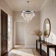 In an entryway | the same chandelier hanging above a console table near the front door