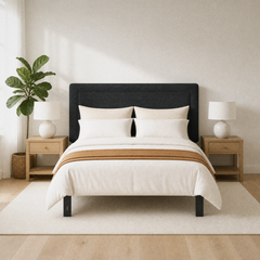 Room 2 | Dark upholstered panel headboard centered in a bright room with pale oak nightstands and a plant