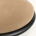 Closer | gold-brown microsuede seat fabric close against the black iron rim