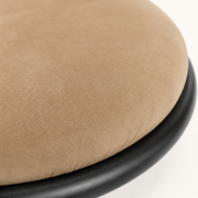 Closer | gold-brown microsuede seat fabric close against the black iron rim