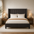 In a room | Straight-on dark gray wingback bed between walnut nightstands, with warm lamps and a cream rug