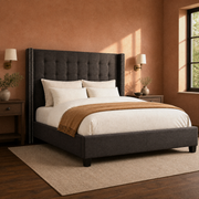 Clay corner | Three-quarter dark gray bed in a warm clay bedroom with brass sconces, dark nightstands, and a textured rug