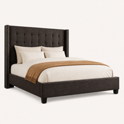 Studio angle | Three-quarter studio view of the dark gray bed with upholstered side rails, footboard, and tapered feet