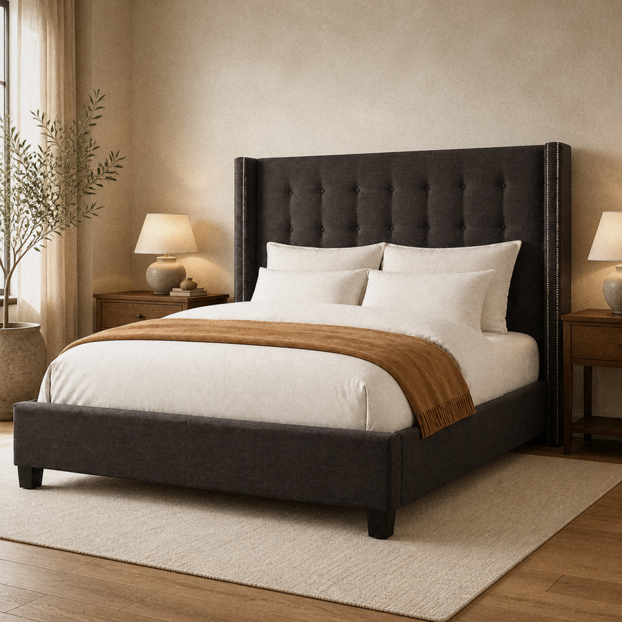 Angle | Three-quarter view of the dark gray wingback bed with its tufted headboard, upholstered rails, and dark feet