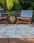 Outdoor patio | the rug shown on a poolside patio with teak lounge chairs