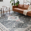 Living room | the rug styled with a leather sofa and reading chair