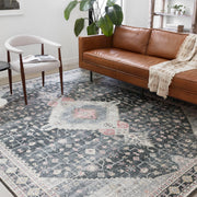 Living room | the rug styled with a leather sofa and reading chair