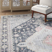 Living room | the rug shown near a mirrored cabinet and reading chair