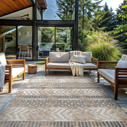 Peris geometric rug on an outdoor patio with wood-frame lounge seating
