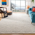 Coastal living room | the rug beneath a teal sofa with an ocean view