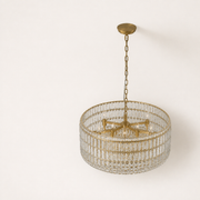 High-angle studio view | gold-tone crystal drum with three crystal bands and beaded skirt