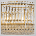 Crystal detail | close view of clear faceted rectangular rods, pyramid caps, gold hooks, and beaded skirt