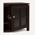 Closer | round brushed-nickel knob and hinge detail on one glass-front door