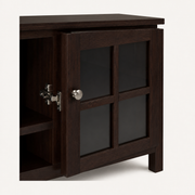 Closer | round brushed-nickel knob and hinge detail on one glass-front door